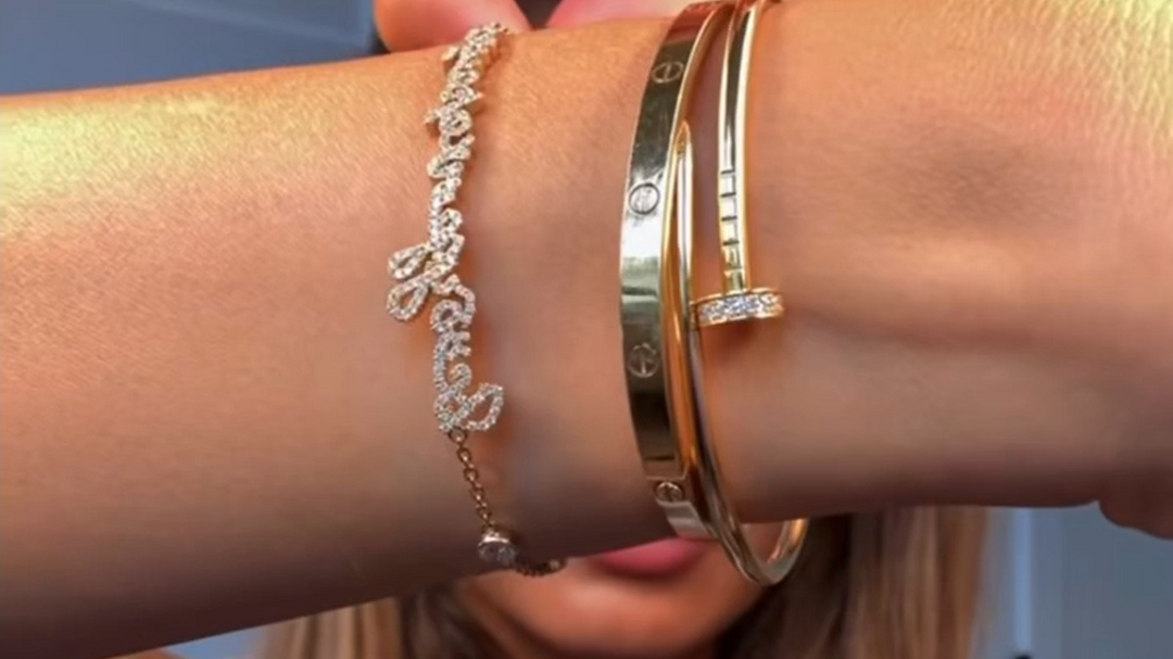 Influencer image with pave diamond handwritten bracelet.  Says in Russian 
Everything will be ok"